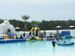 Colorful water park with inflatable slides and people swimming