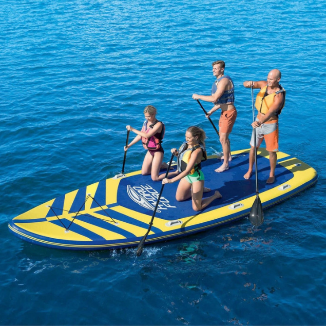 Family enjoying a Giant Family Stand Up Paddle Board on the water in Bintan, Indonesia,