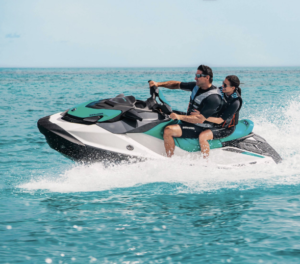 Couple enjoying a guided Jet Ski safari tour on the turquoise waters of Bintan Island,
