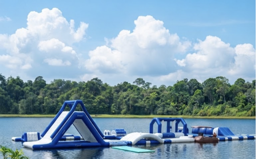 Vibrant inflatable water park at Lagoi Lake, Bintan, featuring slides, obstacles, and floating zones for